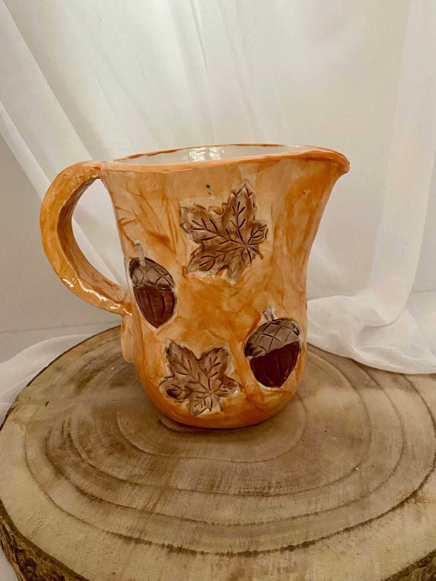 White ceramic pitcher with autumn leaves and acorn decorations from the Autumn Collection, handcrafted and artisan style