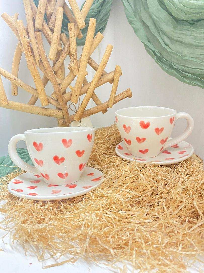 pair of white ceramic cups with saucers decorated with red hearts from Valentine's Day collection