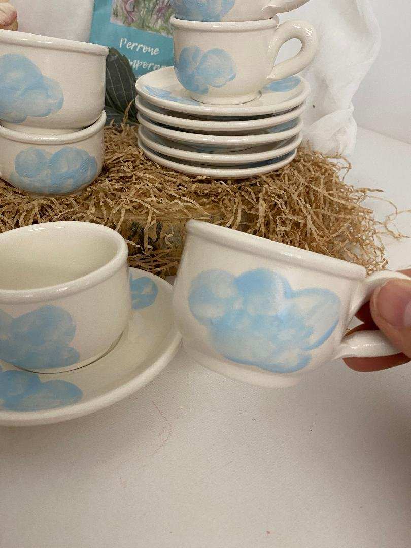 White ceramic Servizio da Caffè cup and saucer set with delicate blue cloud design, Nuvola collection, handmade Italian craftsmanship, set of six.