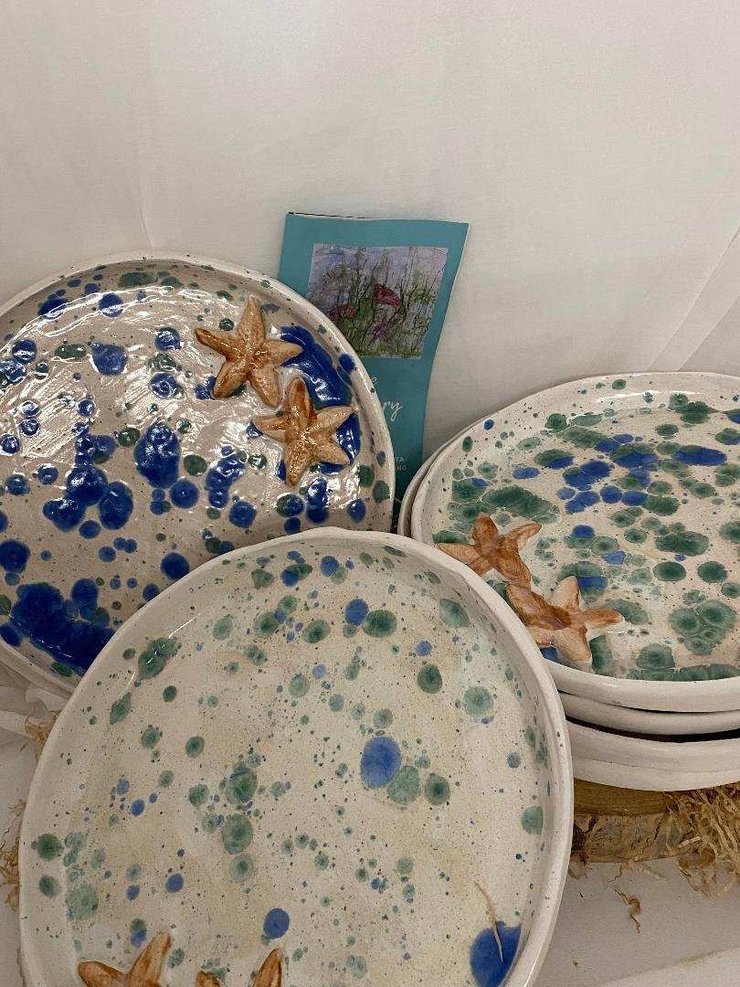 Handcrafted ceramic flat plates set of 6 with blue and green splatter design and starfish decoration, 22cm diameter.