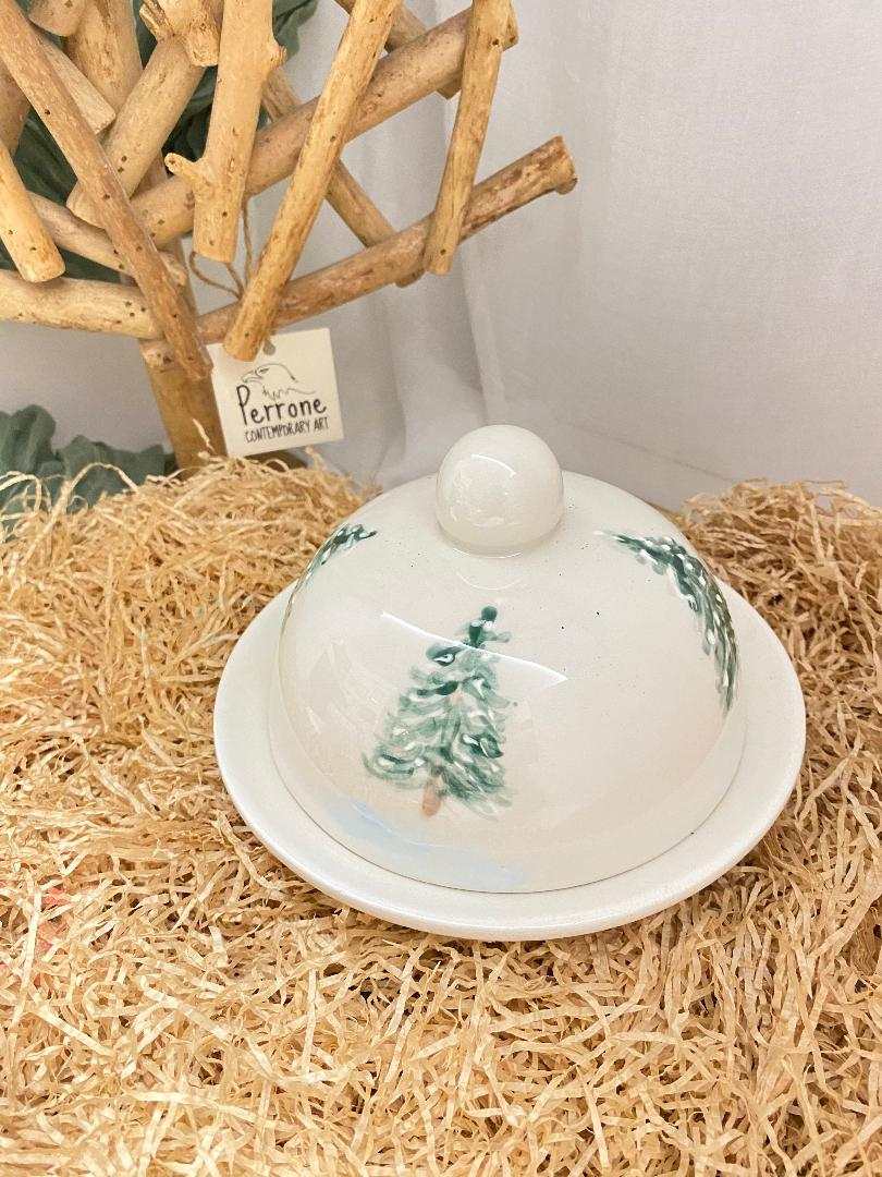 white ceramic butter dish with winter tree design from Inverno collection on straw background
