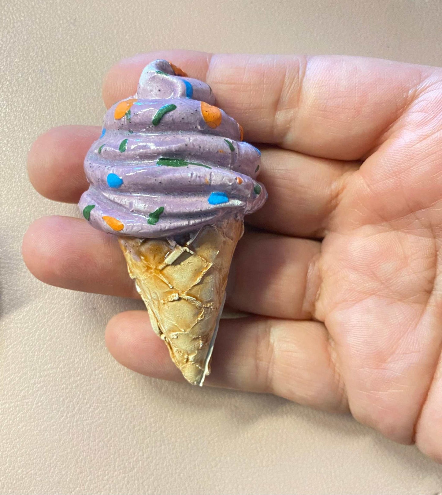 Hand holding a ceramic ice cream cone magnet from Tris calamite in ceramica Collezione Gocce del Salento