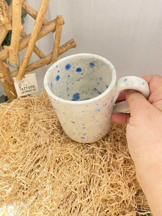 Handmade ceramic mug with soft shape and blue speckled decoration, inspired by summer fruits and Mediterranean colors.