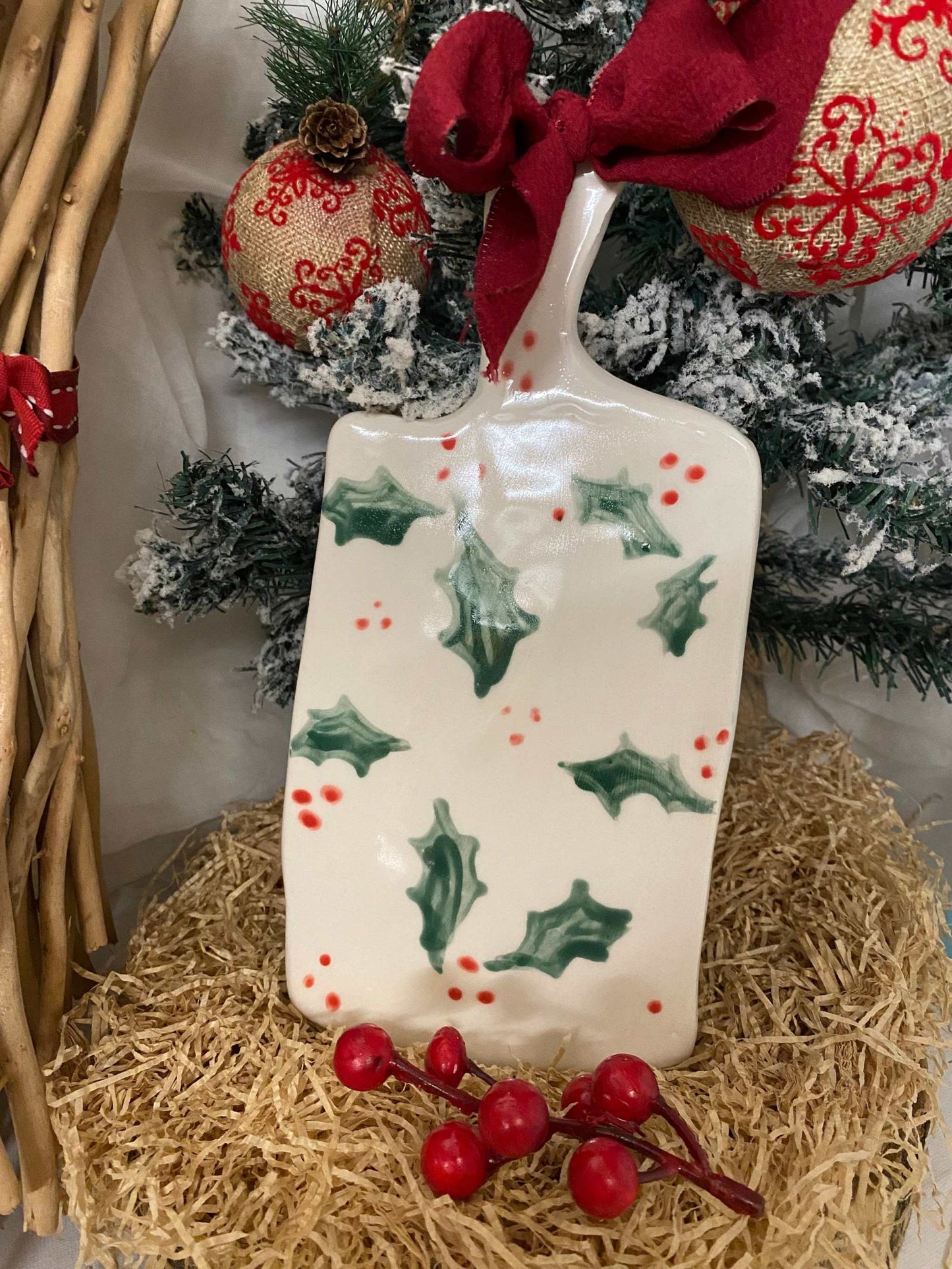 White ceramic cutting board with holly leaf and red berry Christmas design, handmade artisan festive kitchen accessory