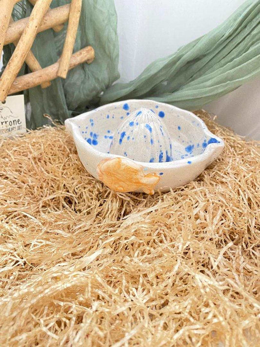 Ceramic citrus juicer with summer collection design and blue speckles for fresh juice preparation