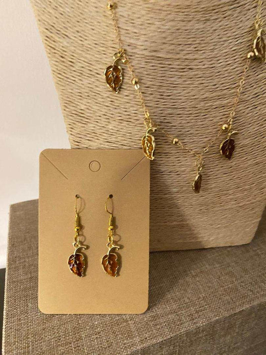 Golden stainless steel earrings with leaf-shaped charms in honey, ruby, and green tones from Luxury Bijioux collection